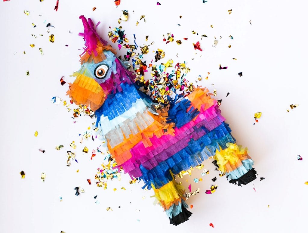 Pinata on the floor with glitter around it