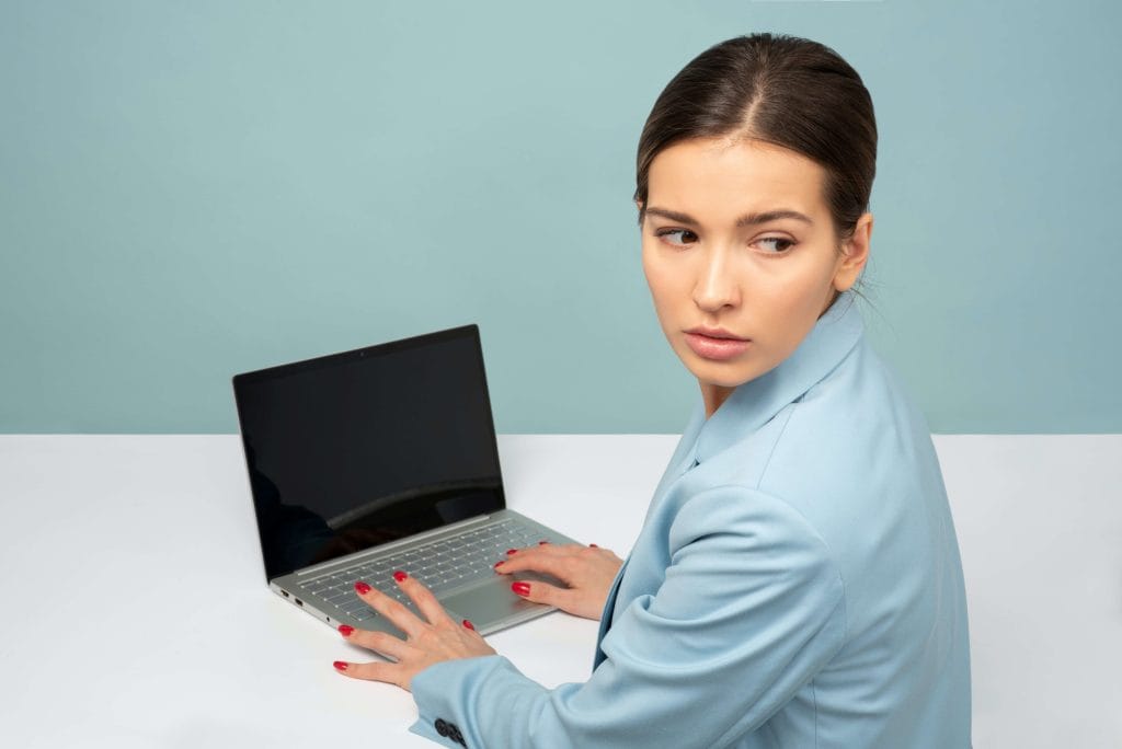 Worried looking woman at desk in front of computer